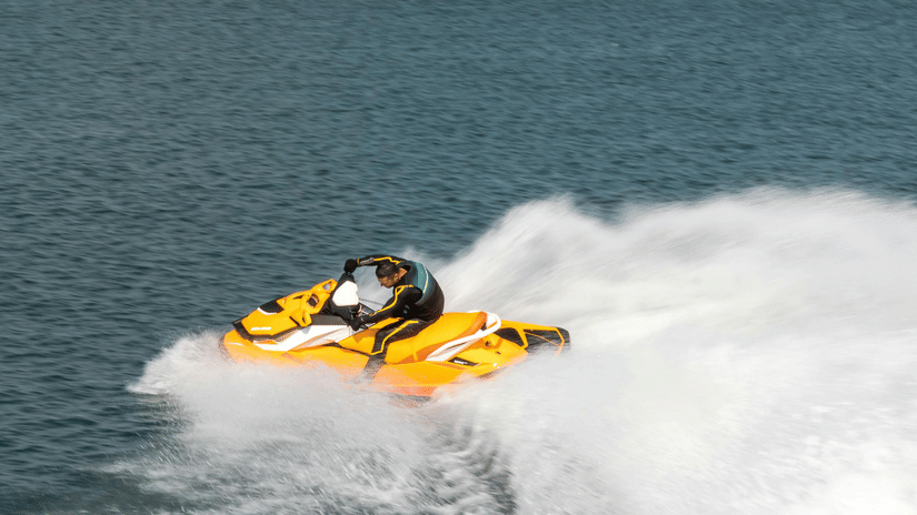 A person riding a jet ski on a clear, blue day