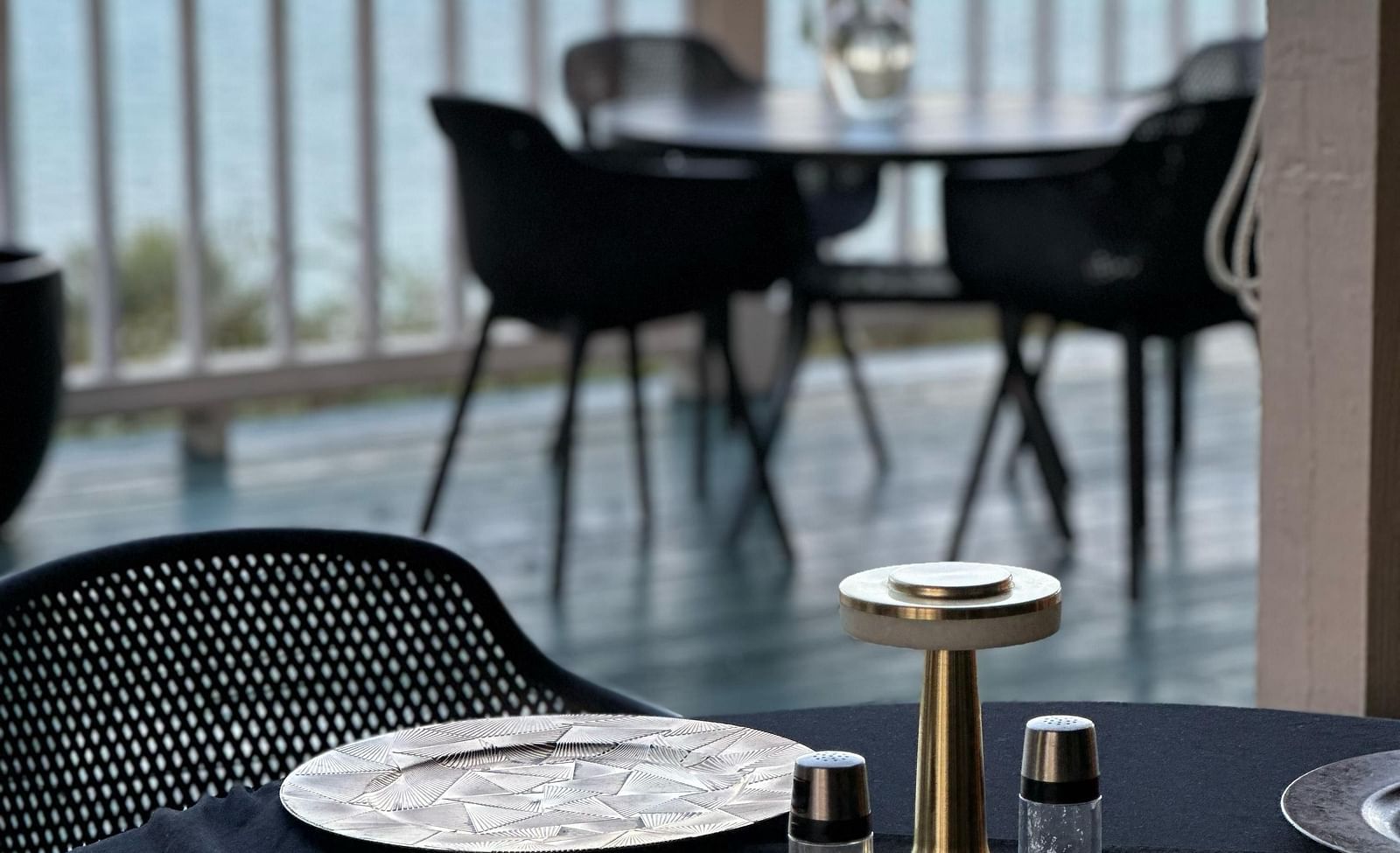 A table set with plates and cutlery overlooking ocean view | A Stone's Throw Away
