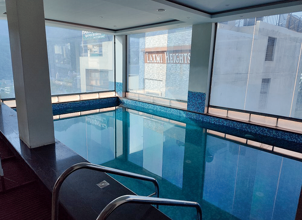 A swimming pool at Regenta Inn DLS with calm waters.