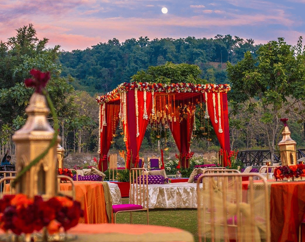 Outdoor wedding reception setup with tables and chairs.