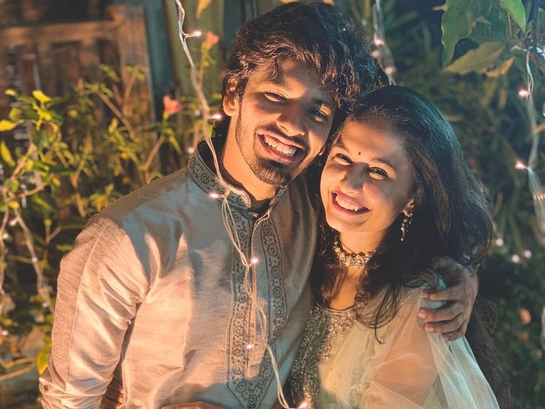 Happy couple in matching silver dress - Rhythm Lonavala