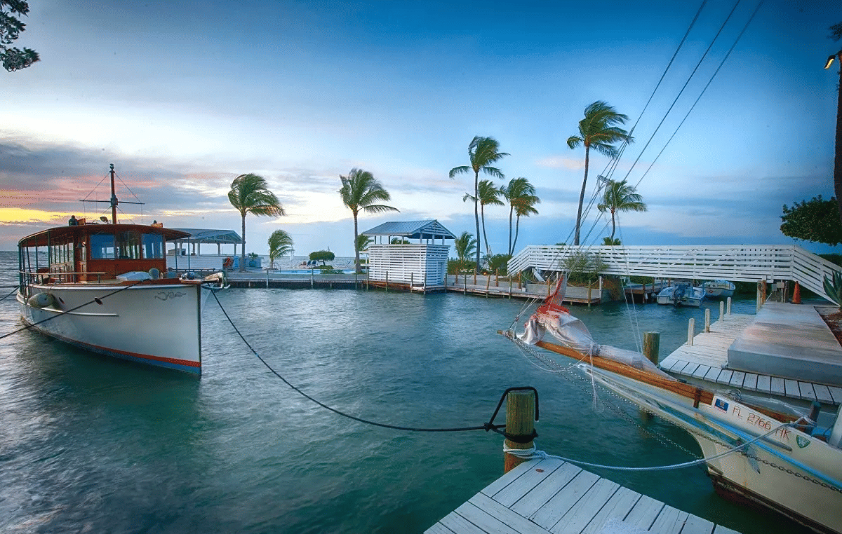 Several boats on a small dock area with a beautiful sunset in the background at Casa Morada.