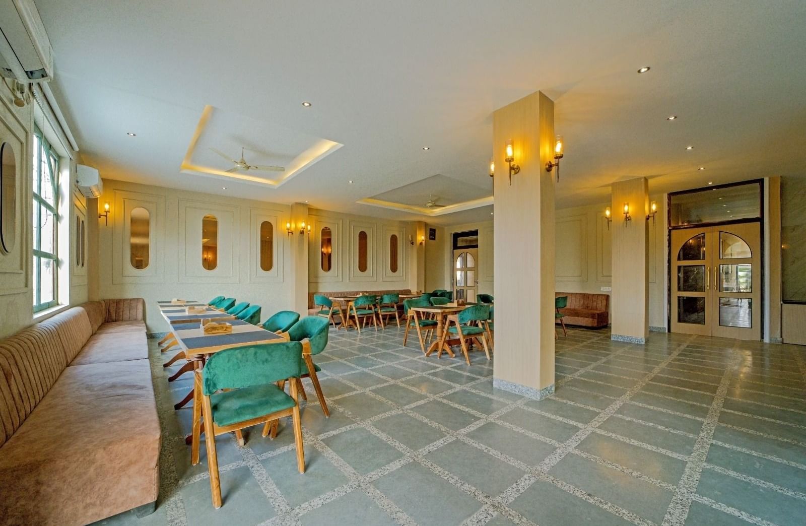 Dining area at Grassfield Riviera Resort, Jaipur, featuring stylish seating, soft lighting, and a spacious, elegant atmosphere.