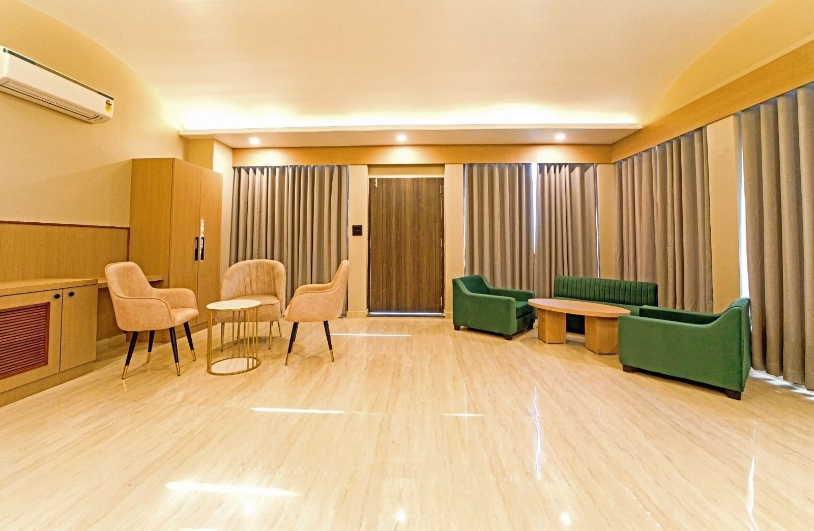 Spacious area at Grassfield Riveria Resort, Jaipur, with comfortable seating, large windows, and ambient lighting.