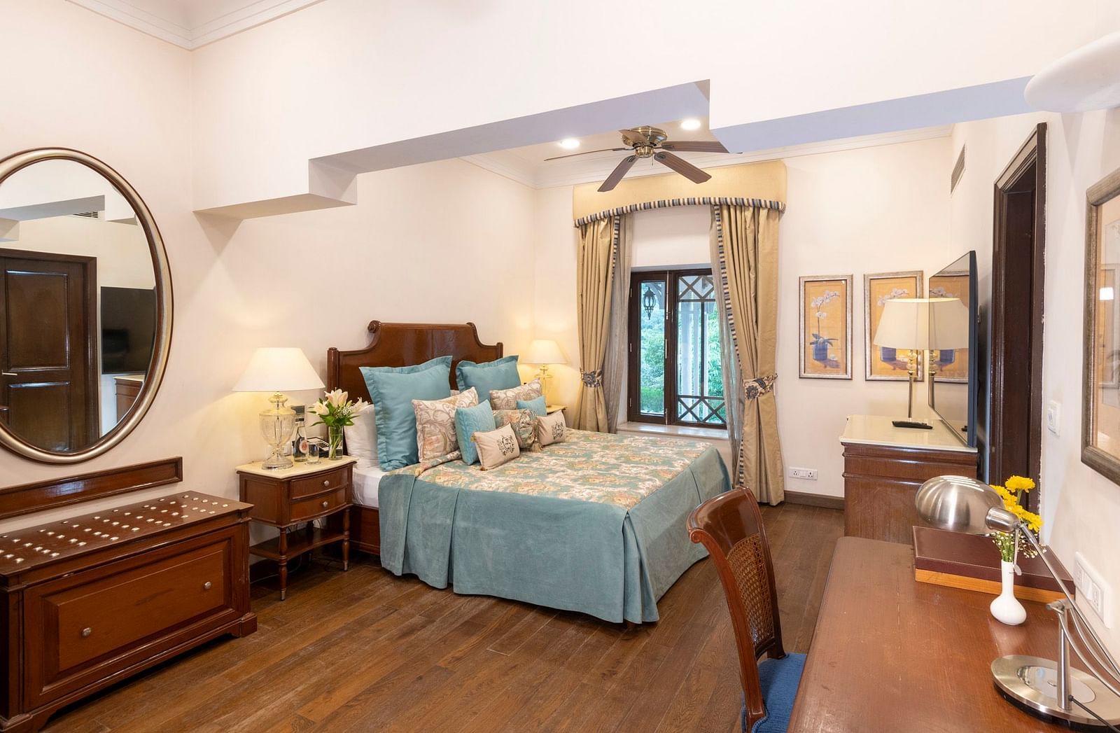 view of the deluxe room with king sized bed and a mirror and a workspace at the Claridges Nabha Residence, Mussoorie