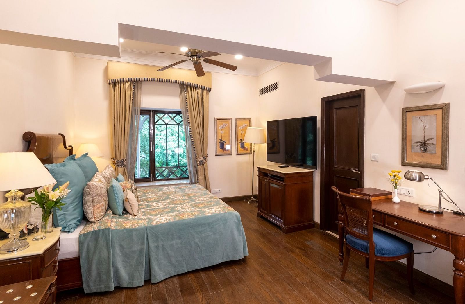 view of the deluxe room with king sized bed and a mirror and a workspace at the Claridges Nabha Residence, Mussoorie
