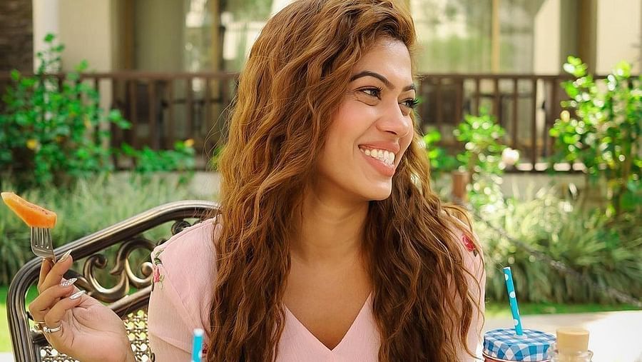 A woman looks happy as she savours her food - Rhythm Lonavala