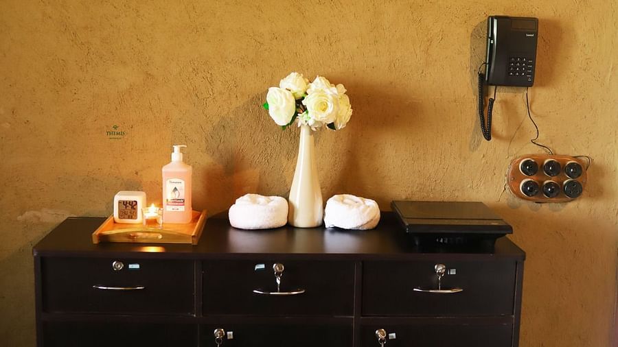 a closeup shot of a table decked with lotions and flowers at Themis Mudhouse - A Nature's Retreat Resort & Wellness
