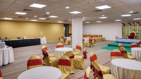 Deluxe Room with twin beds and a well lit corridor view at Featherlite Evoma Hotel.