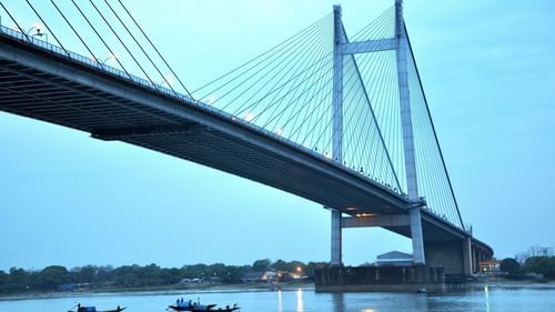 view of howrah bridge and boats cruising beneath the bridge on the river 1