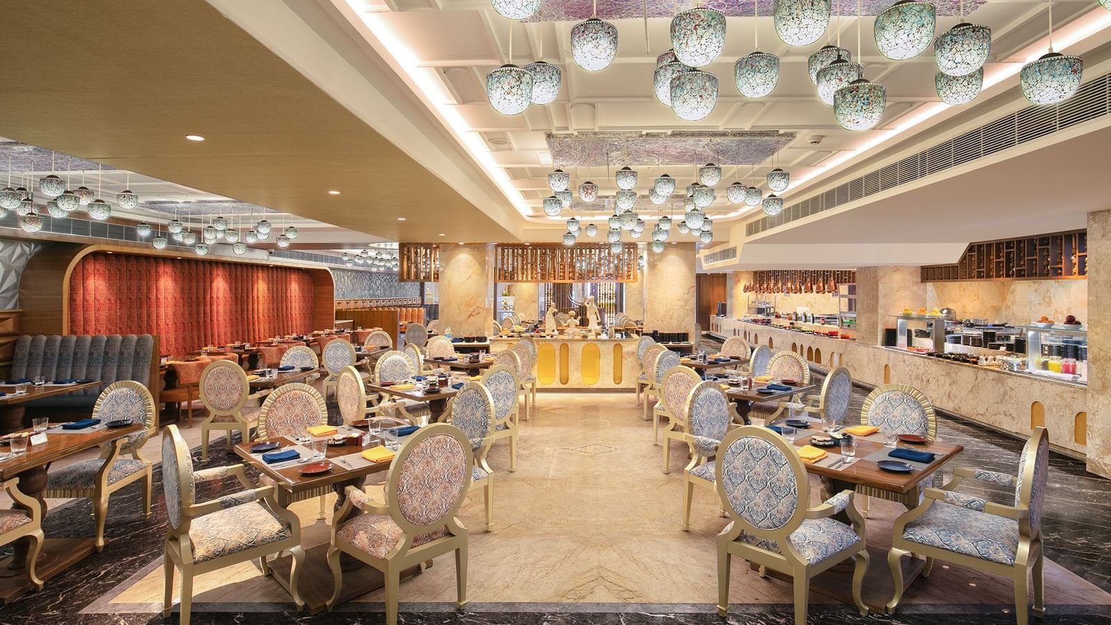 A spacious dining hall featuring modern decor and warm lighting - Kaldan Samudhra Palace
