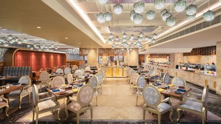 A spacious dining hall featuring modern decor and warm lighting - Kaldan Samudhra Palace