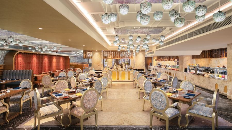 A spacious dining hall featuring modern decor and warm lighting - Kaldan Samudhra Palace