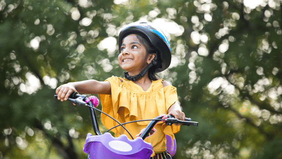 Child cycling in a park representing family-friendly activities at Sabarmati Riverfront
