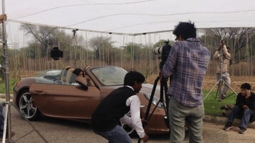 A photoshoot of an open top car with the photographer in view - Karma Lakelands.