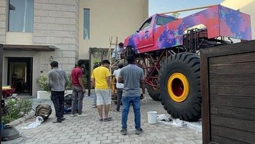 a group of people next to a monster car during a photoshoot - Karma Lakelands.