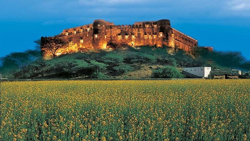 The facade of Hill Fort Kesroli Kesroli with grass at the forefront