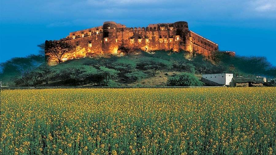 The facade of Hill Fort Kesroli Kesroli with grass at the forefront