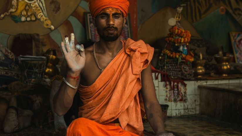 A Hindu priest sitting in a meditative pose.
