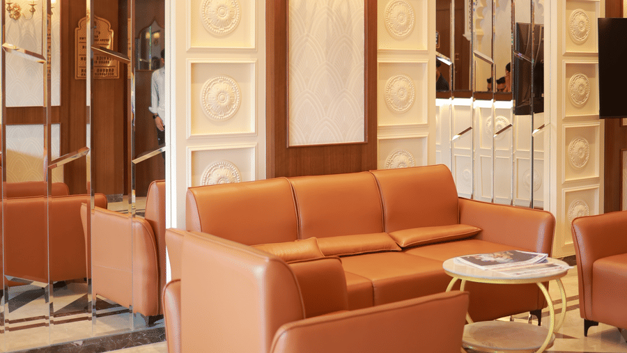 Lobby seating area with armchairs and marble flooring at Hotel Mumbai House Digha, Airoli.