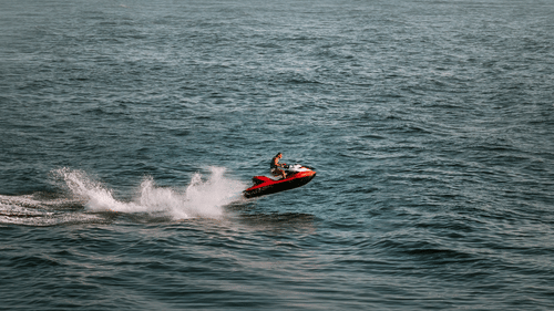 a far out view of a person jet skiing in the ocean