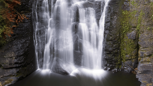 a waterfall cascading down a hill 1