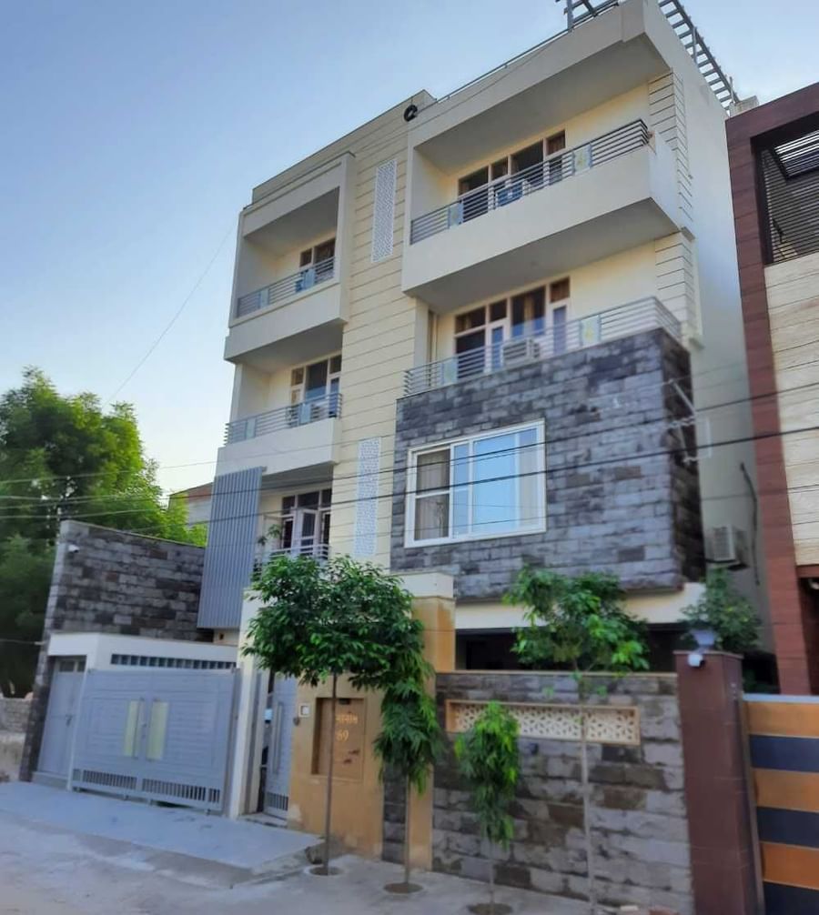 Exterior view of the contemporary homestay building with balconies and modern design at Jaypore360 Homestay.