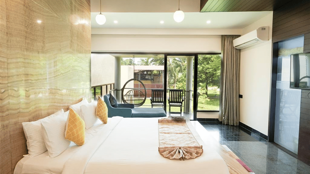 An elegant Grandeur Suite - Abode Executive Lounge Access at MGM Dizzee World featuring a big bed, modern lighting, a seating area and a private balcony.