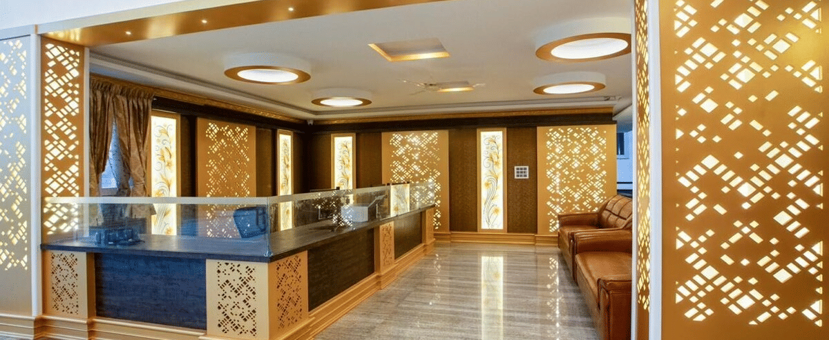 Duplicate of Stylish reception area with golden panelling and modern ceiling lights at Siri Ambari Resorts and Spa.