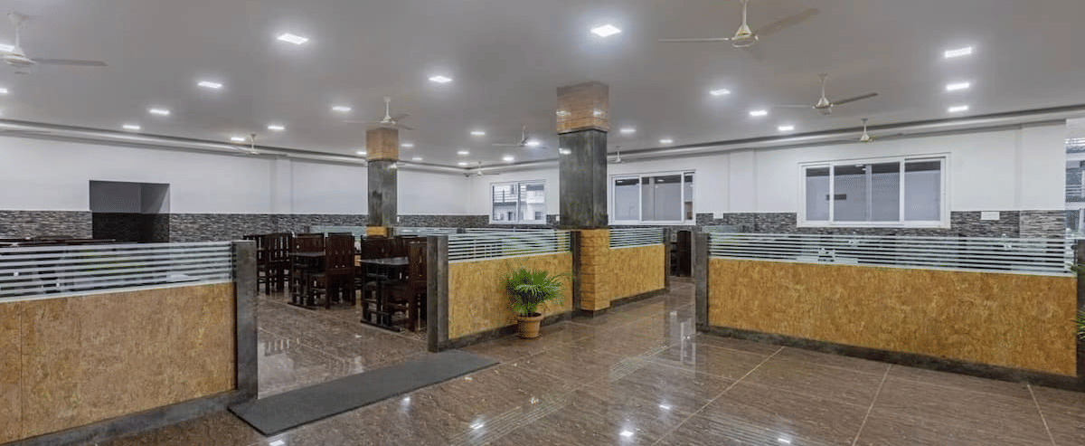 Brightly lit buffet area with organised counters and seating at Siri Ambari Resorts and Spa.