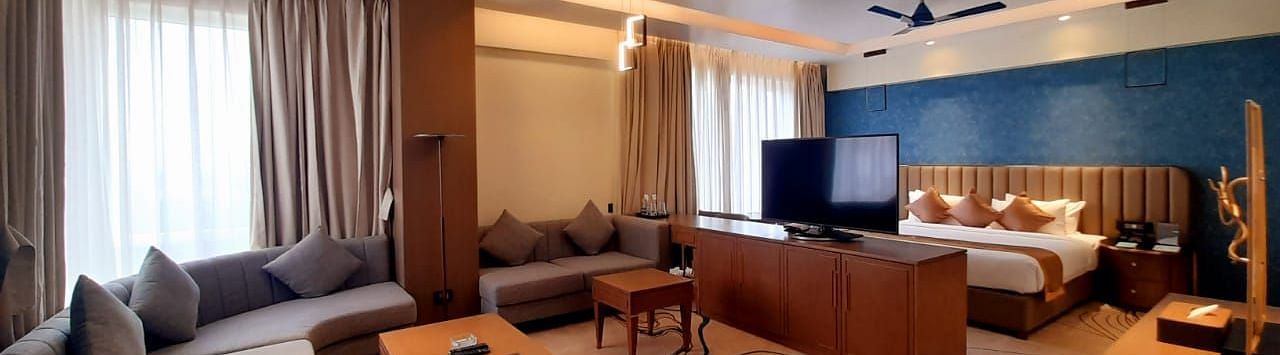 a view of the living room and the king size bed of M-Suite at Wonder country club resort