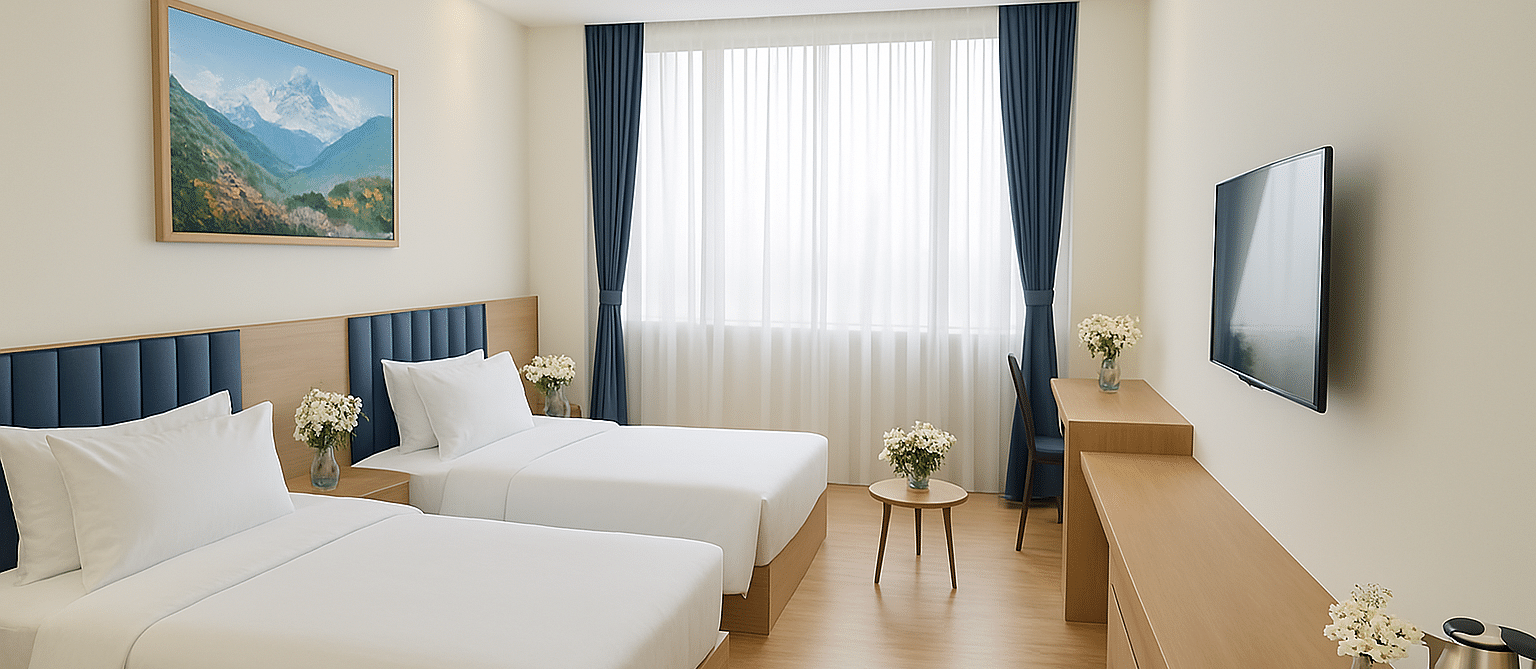 Side view of Executive Twin Room with cosy twin beds, wall-mounted TV, and a corner chair-table setup at Summit Norling Resort & Spa, Gangtok