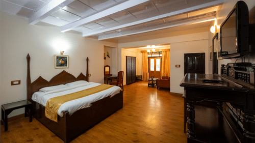 Side view of Balcony Room with a cosy bed at The Pavilion, Nainital