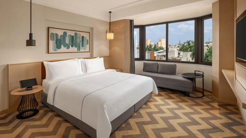 Suite room featuring a cozy bed and elegant bedside lamps at The Residency Chennai