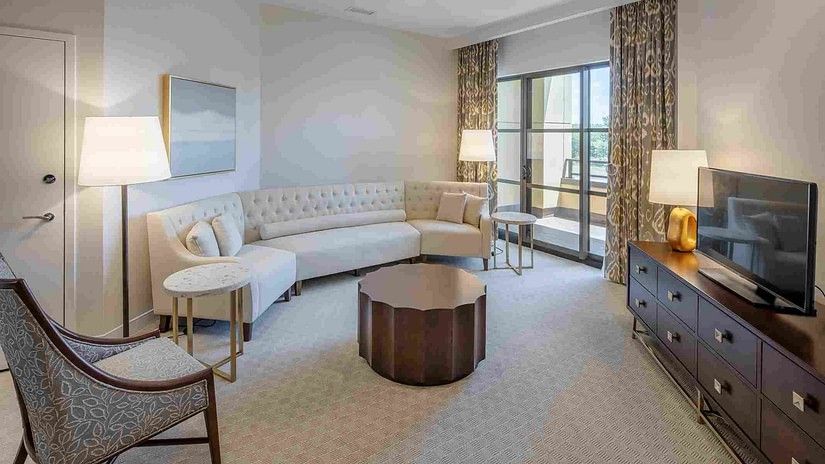 A suite with a cosy sofa, a TV in front of it and an elegant coffee table at the center at YO1 Lonevity & Health Resorts, Catskills