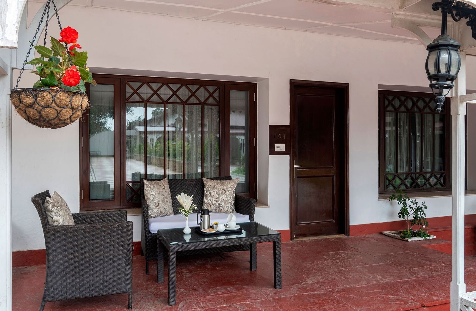 Outside seating area with a three seater couch at The Claridges Nabha Residence