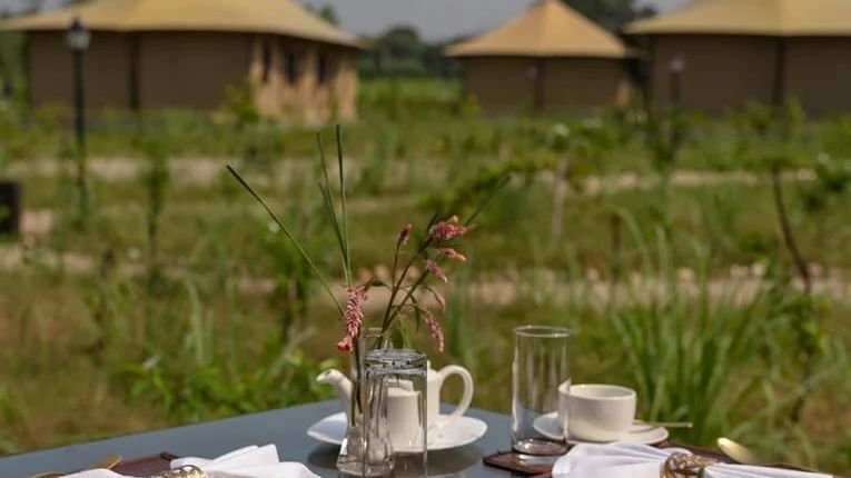 An image of high tea setup with our beautiful tents in the background - Claridges Collection