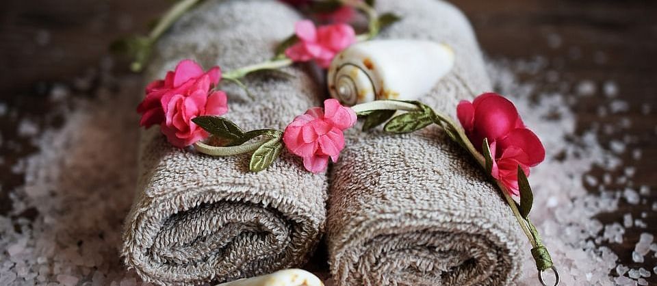 Image of towels with flowers on top of it