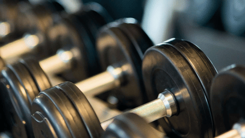 weights stacked one by one at a gym
