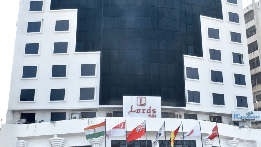 Facade of Lords Plaza Surat featuring its parking space and entrance
