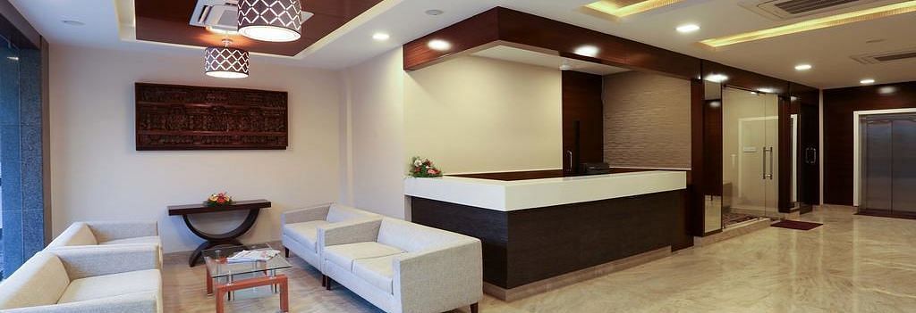 Siting area with two sets of spacious sofa and a coffee table at Fressotel Seetharam, Coimbatore