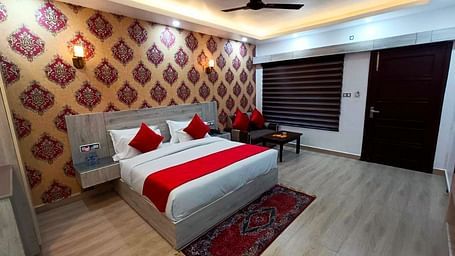 A Premium Room at DLS Nature Trinket Resort  with a king size bed and side tables.