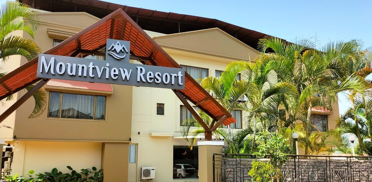 Mountview Resort entrance in Lonavala featuring lush greenery, spacious driveway, and clear resort signage for a welcoming first impression.