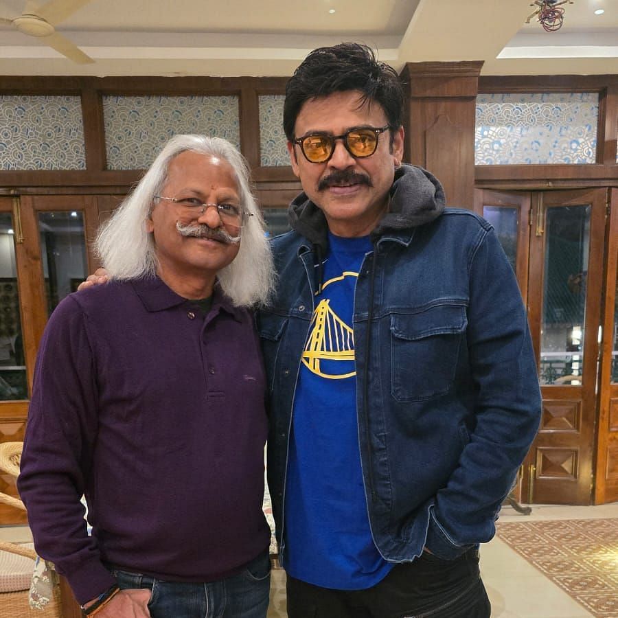 Image of  two people posing for a picture inside a room with beautiful setting 