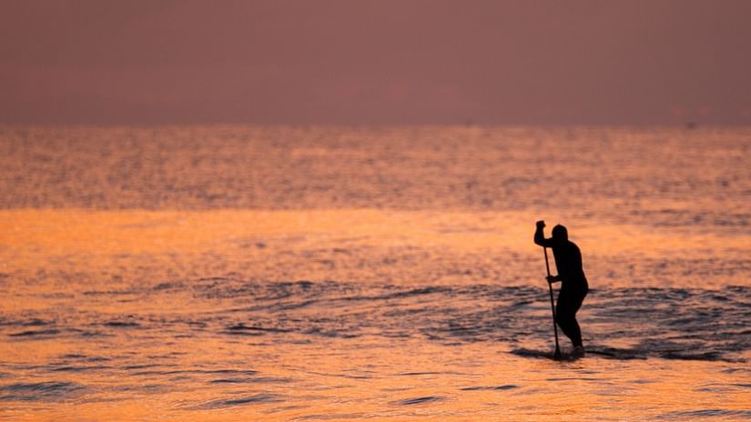 silhouette-photo-of-person-riding-a-paddle-board-during-2489475