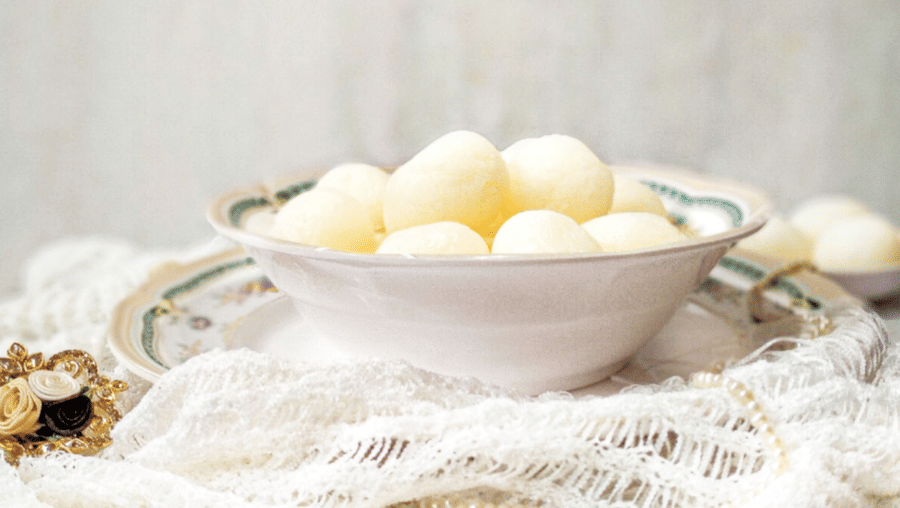 A bowl full of rasgulla, a traditional Bengali sweet.