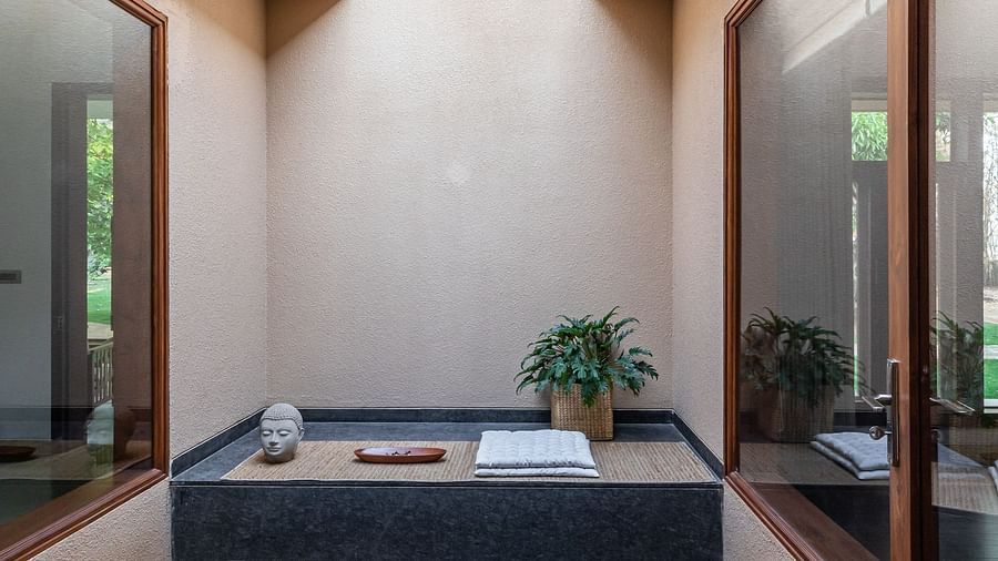 Bathroom with a dark bathtub, stone pebbles, skylight, natural light, modern design - Shreyas Retreat