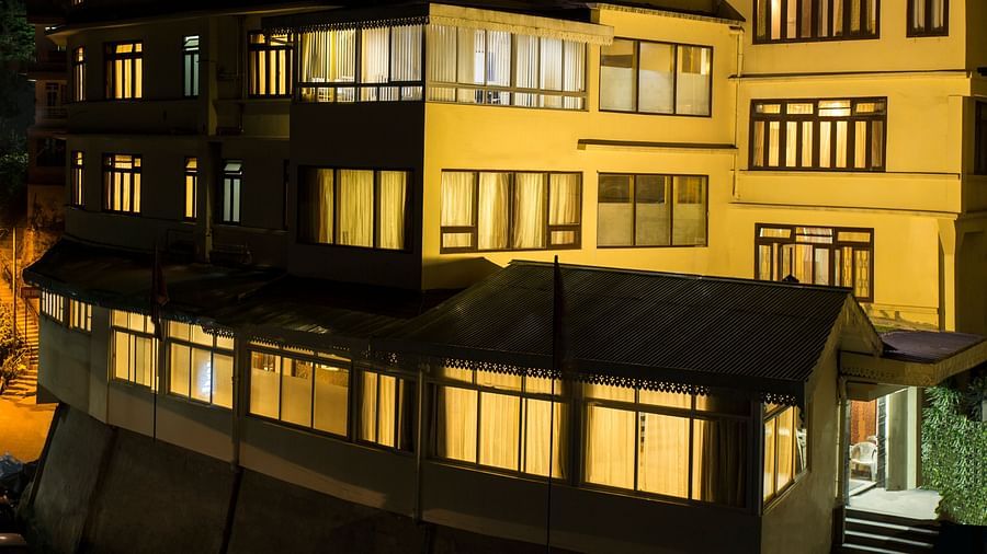 The New Orchid Lords Inn Gangtok illuminated at night, showcasing its multi-story structure.