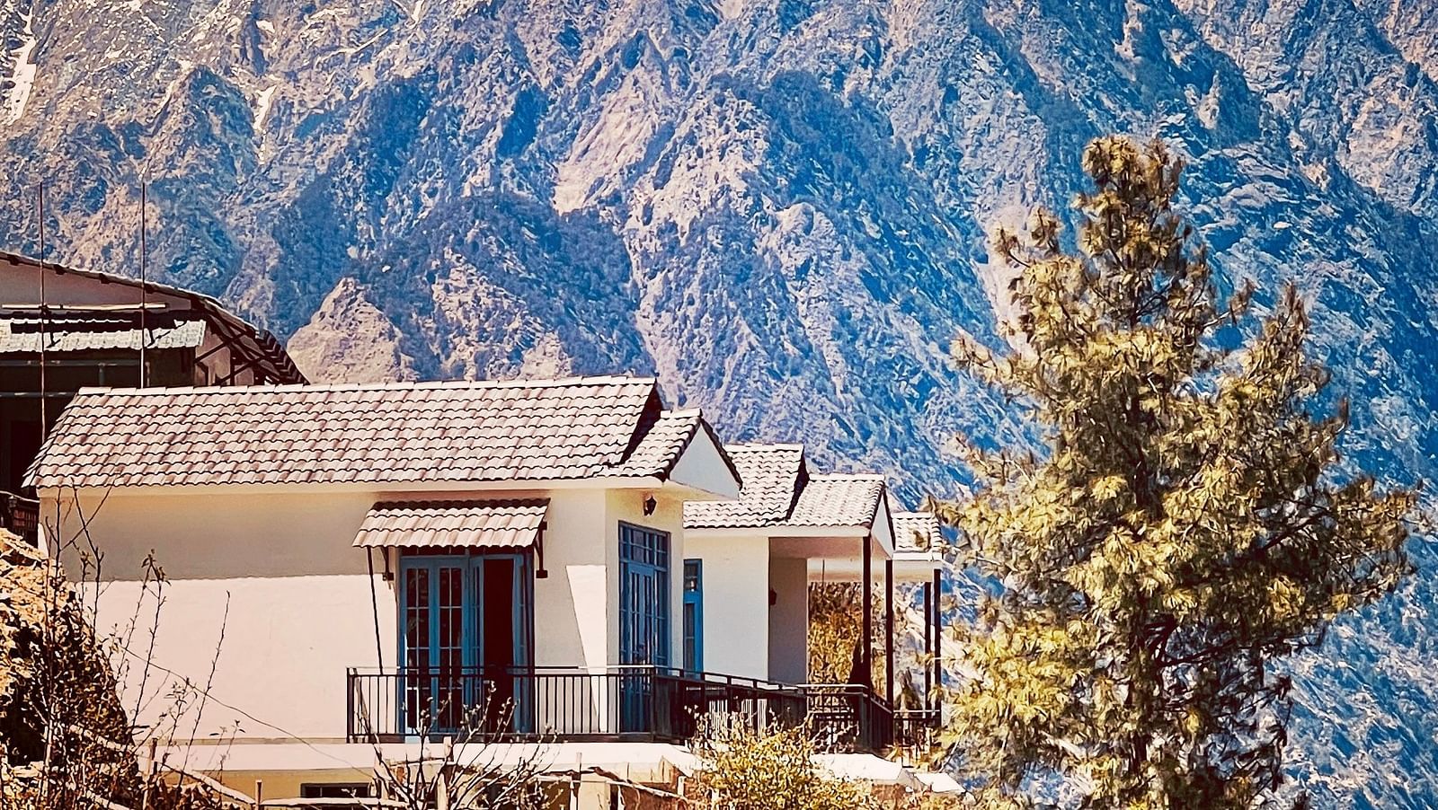 Image of the facade of Faraway Cottages, Auli and mountains in the background | Faraway Cottages, Auli