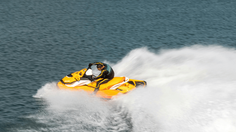 A person riding a jet ski on a clear, blue day